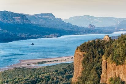 The Columbia River Gorge Vista House is perched atop a hill overlooking the Columbia River, nestled between Oregon and Washington.