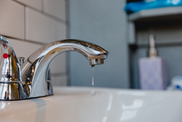 A home faucet drips to prevent frozen home plumbing pipes.