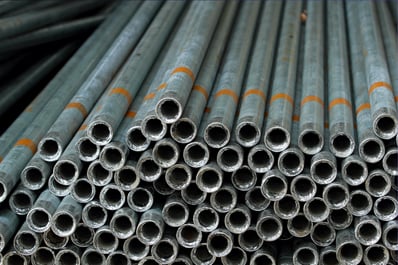 A pile of galvanized steel pipes with an open side exposed to the camera, allowing the viewer to see how thick and durable they are.