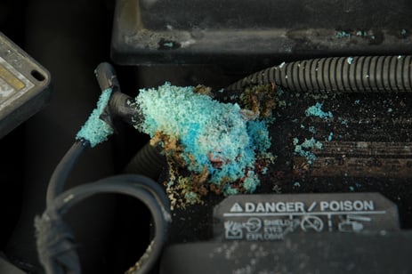 A blue green battery corrosion is highly visible on a generator battery terminal.