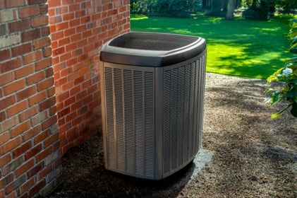 An outdoor Lennox Heat Pump unit sits on a small concrete slab, green grass surrounding it.