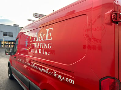 A shot of an A&amp;E van with the A&amp;E Plumbing, Heating and Air Gresham location in the background.