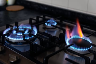 A natural gas stove with an open flame.