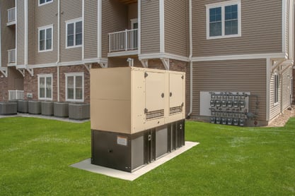 A shot of an outdoor residential diesel generator with the home in the background.