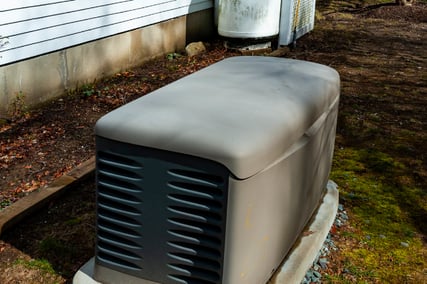 An outdoor residential generator during a fall day.