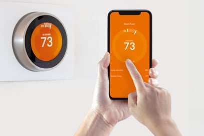 A user shows how easy it is to control a smart thermostat on their phone.