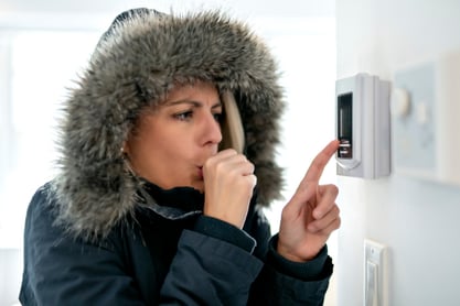 A woman adjusts her home's thermostat in hopes of stabilizing her whole house temperature.